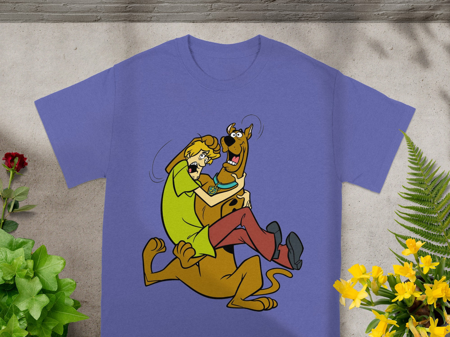 Scooby-Doo and Shaggy in a playful embrace on a purple t-shirt.