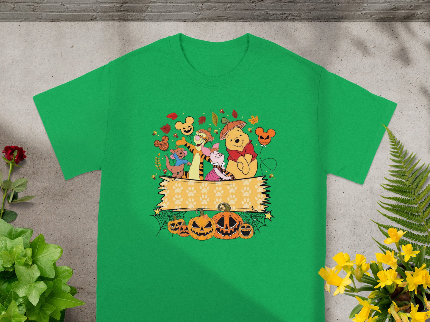 Winnie the Pooh characters celebrate Halloween with pumpkins and fall leaves.