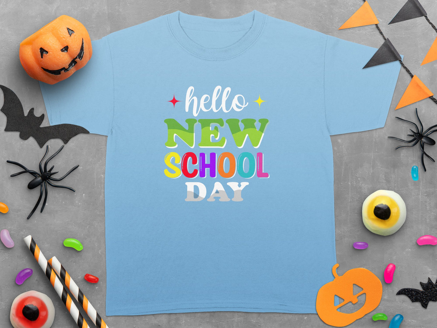 Light blue t-shirt with "hello NEW SCHOOL DAY" text and Halloween decorations.