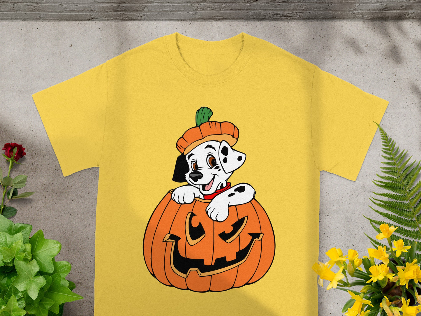 Dalmatian puppy in a pumpkin costume on a yellow t-shirt.
