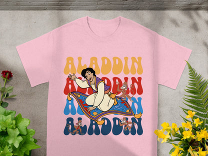 Aladdin, Abu, and magic carpet graphic on a pink t-shirt.
