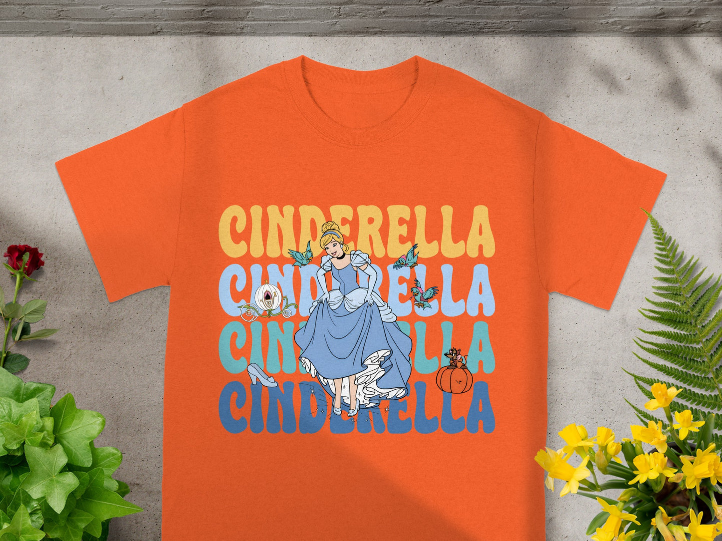 Orange t-shirt with Cinderella graphic and text.