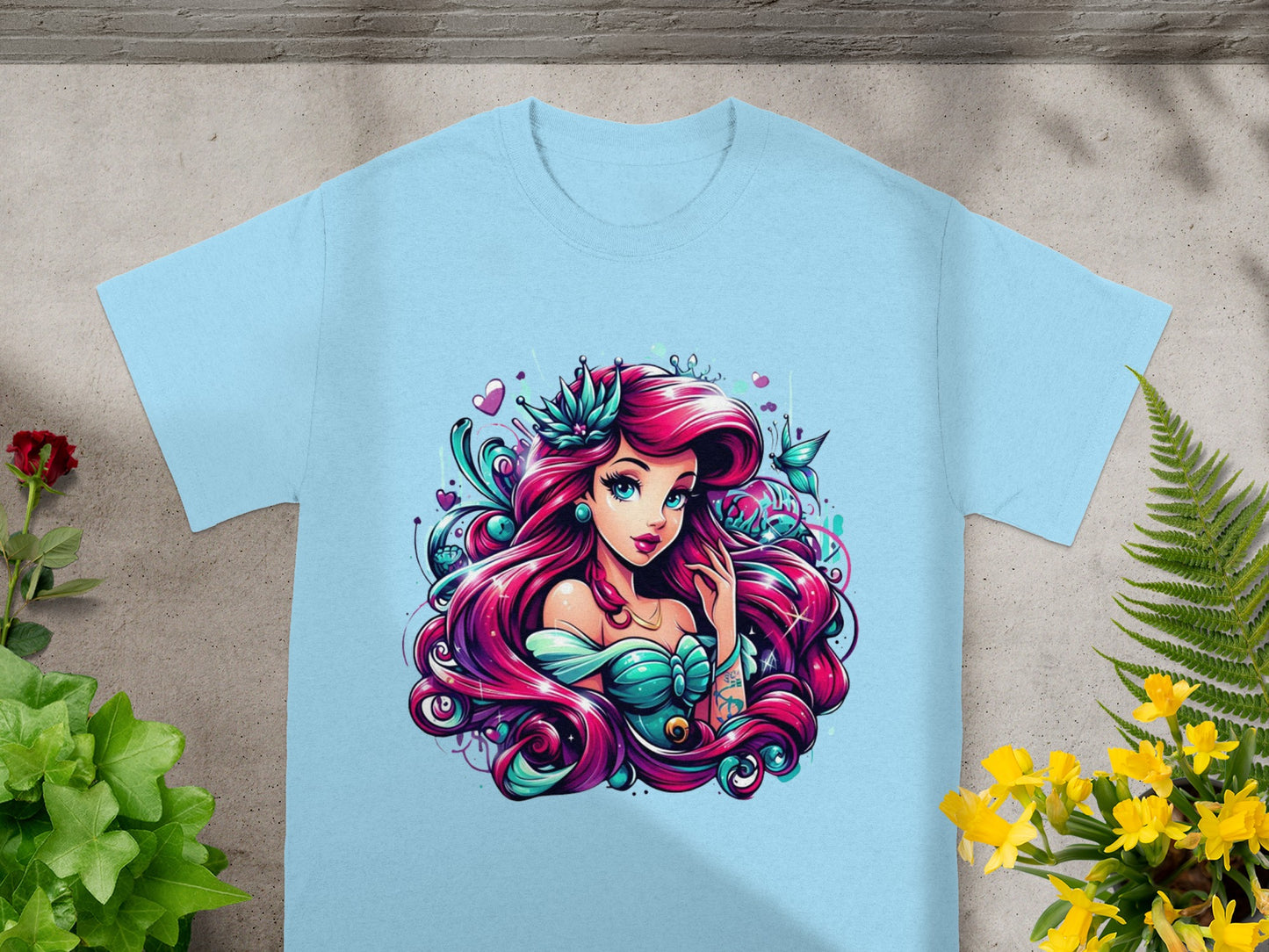 Light blue t-shirt featuring a stylized illustration of a mermaid with long, flowing pink hair.