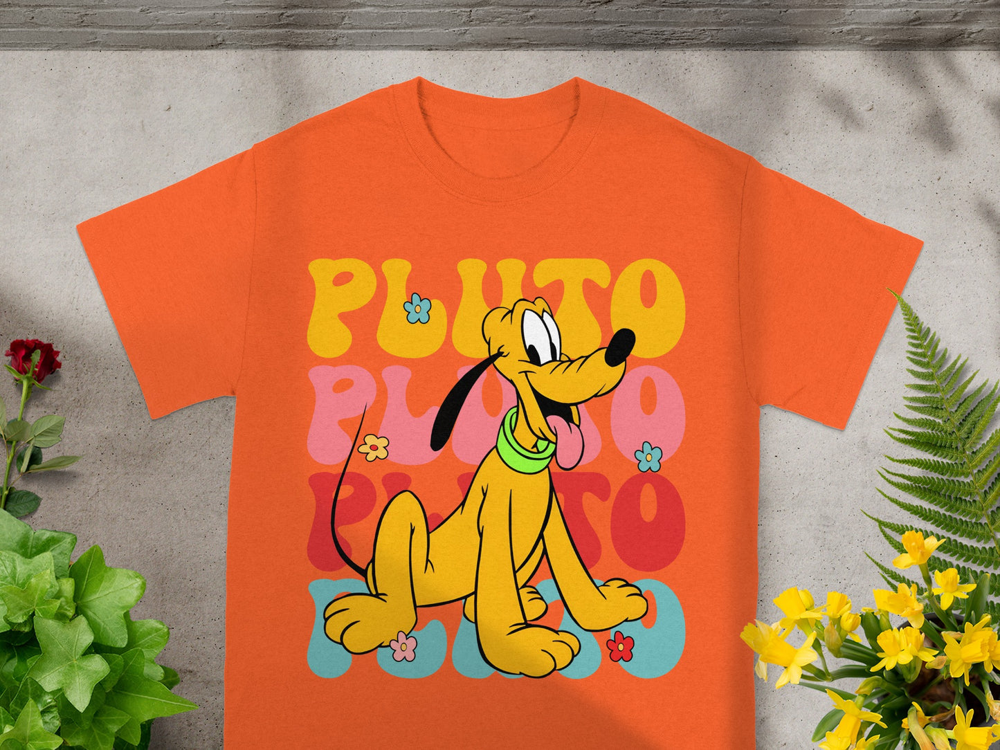 Orange t-shirt with retro Pluto graphic and "Pluto 2000" text.