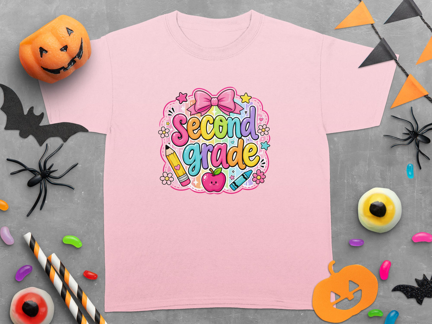 Pink t-shirt with "Second Grade" cartoon text, apple, pencil, and crayon.