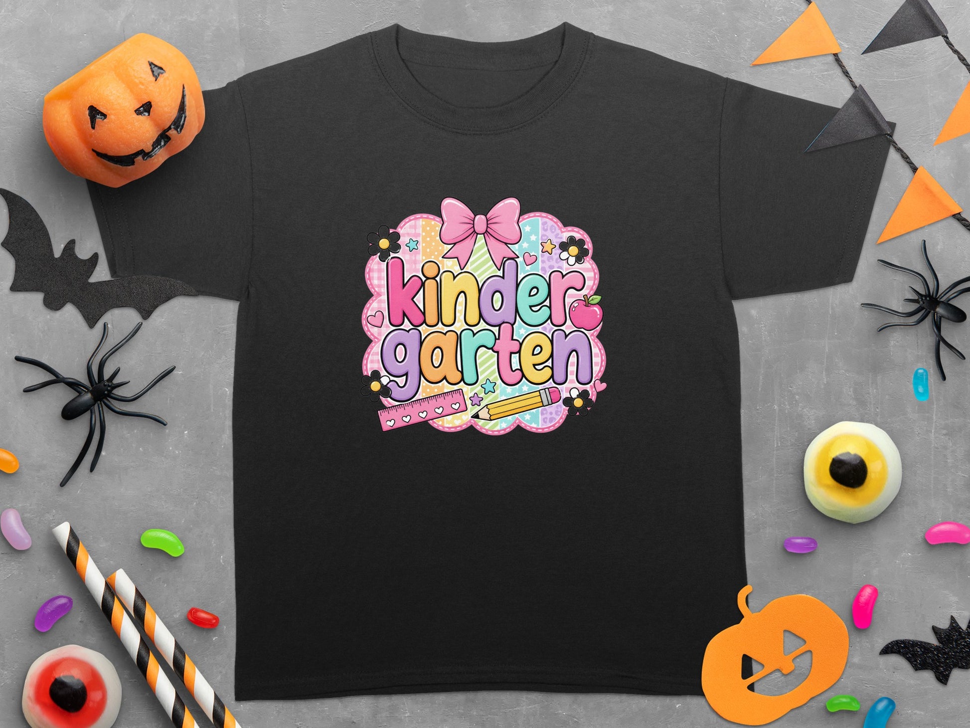 Black t-shirt with colorful "kinder garten" text and Halloween decorations.