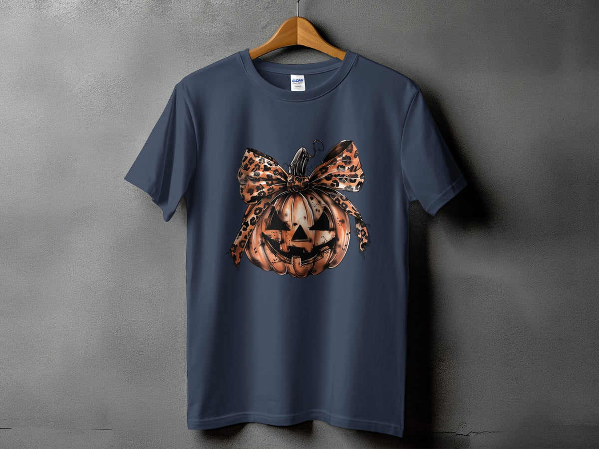 Navy t-shirt with a jack-o'-lantern graphic featuring a leopard print bow.
