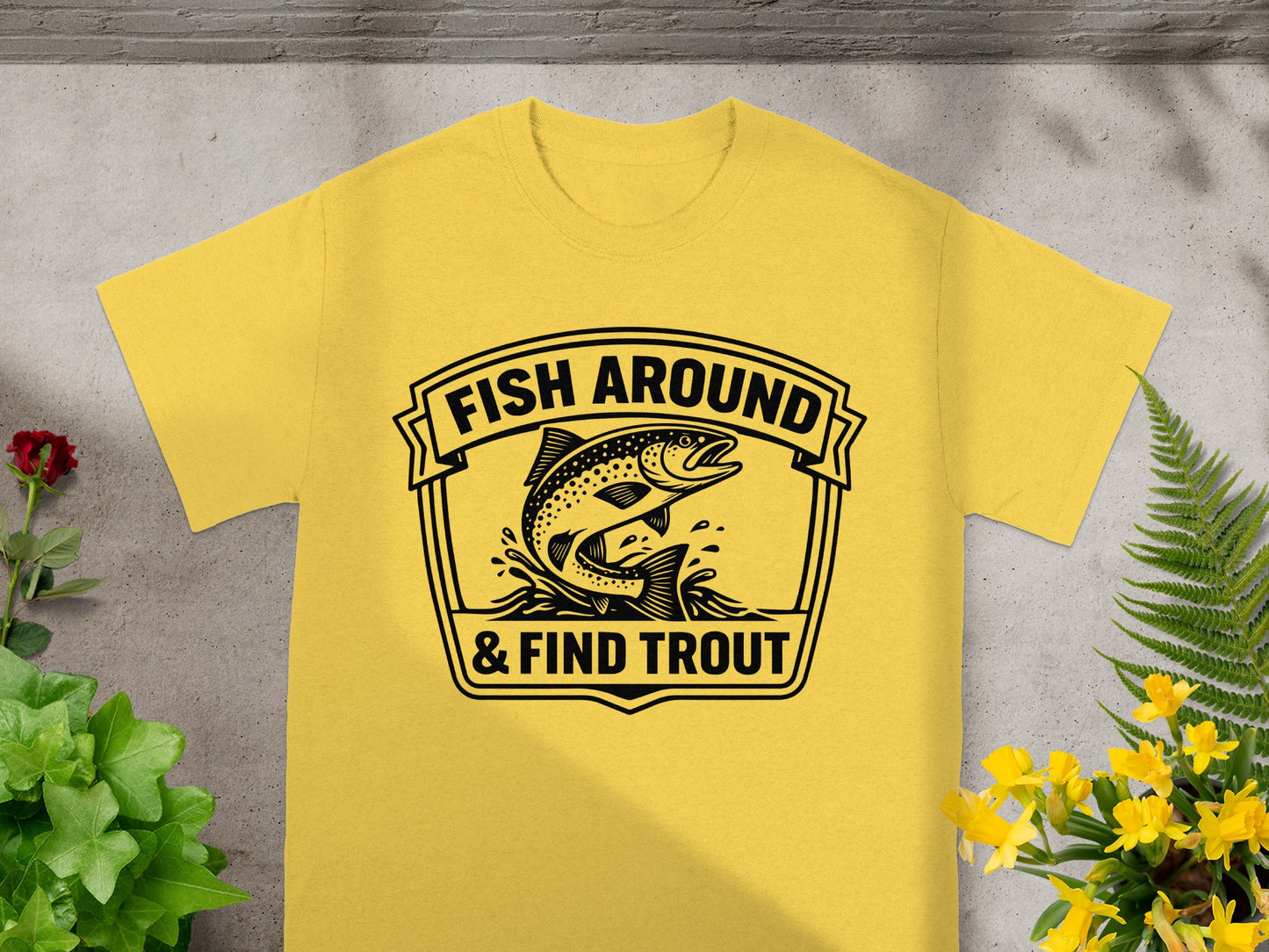 Yellow t-shirt with "FISH AROUND & FIND TROUT" and flying trout graphic.