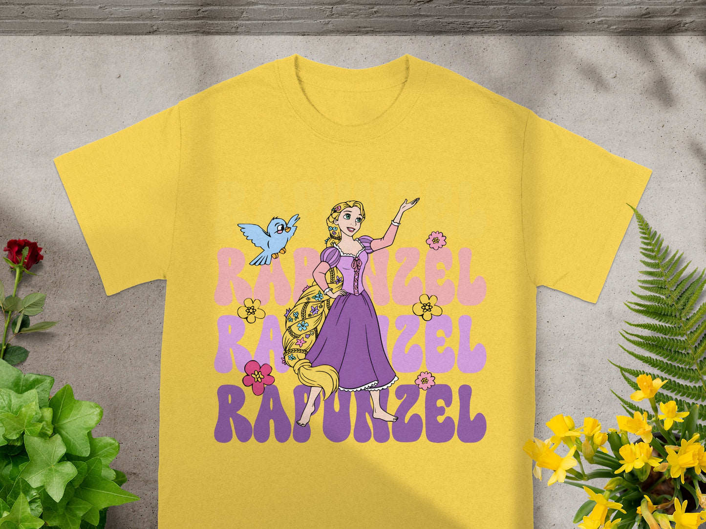Yellow t-shirt with Rapunzel and friend, purple text "Rapunzel".