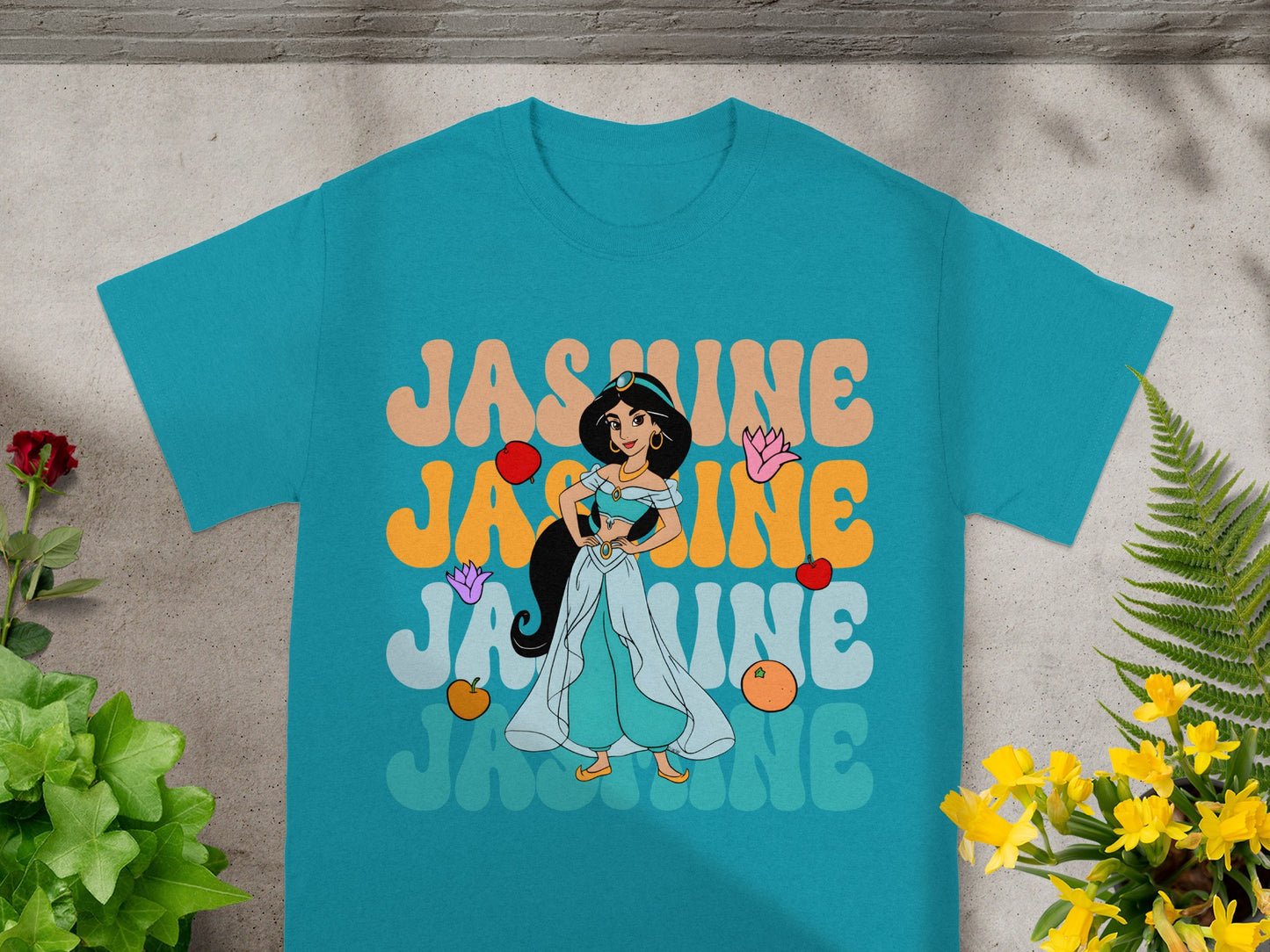 T-shirt with teal background featuring Jasmine from Aladdin with layered text.