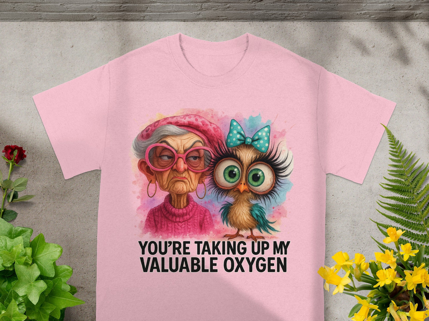 Pink t-shirt with watercolor graphic of an elderly woman and an owl, text says "You're Taking Up My Valuable Oxygen."