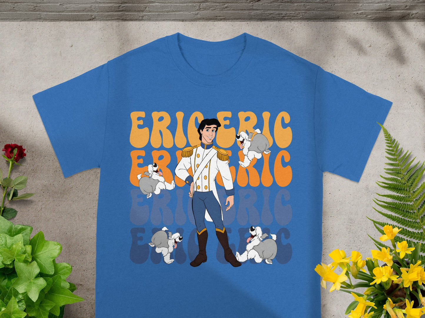 Prince Eric with his dogs on a blue t-shirt with orange text.