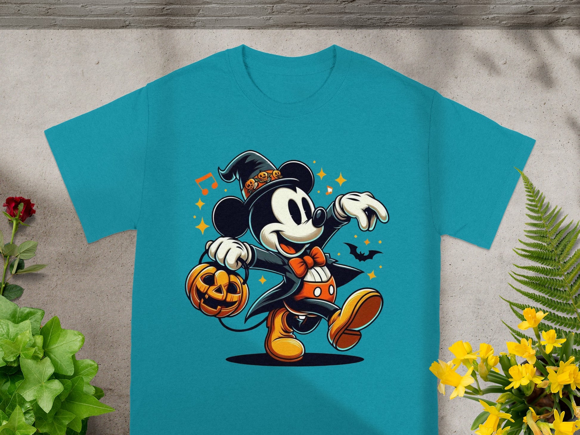 Mickey Mouse in Halloween costume holds a pumpkin while wearing a witch hat.