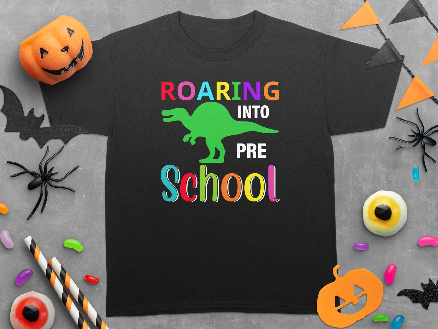 Black t-shirt with "ROARING INTO PRE School" text and green dinosaur graphic.