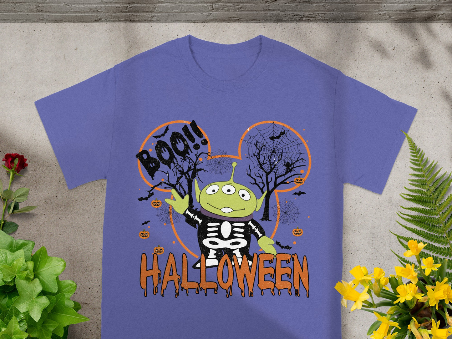 Alien character in skeleton costume with "Boo!!" and "Halloween" text.