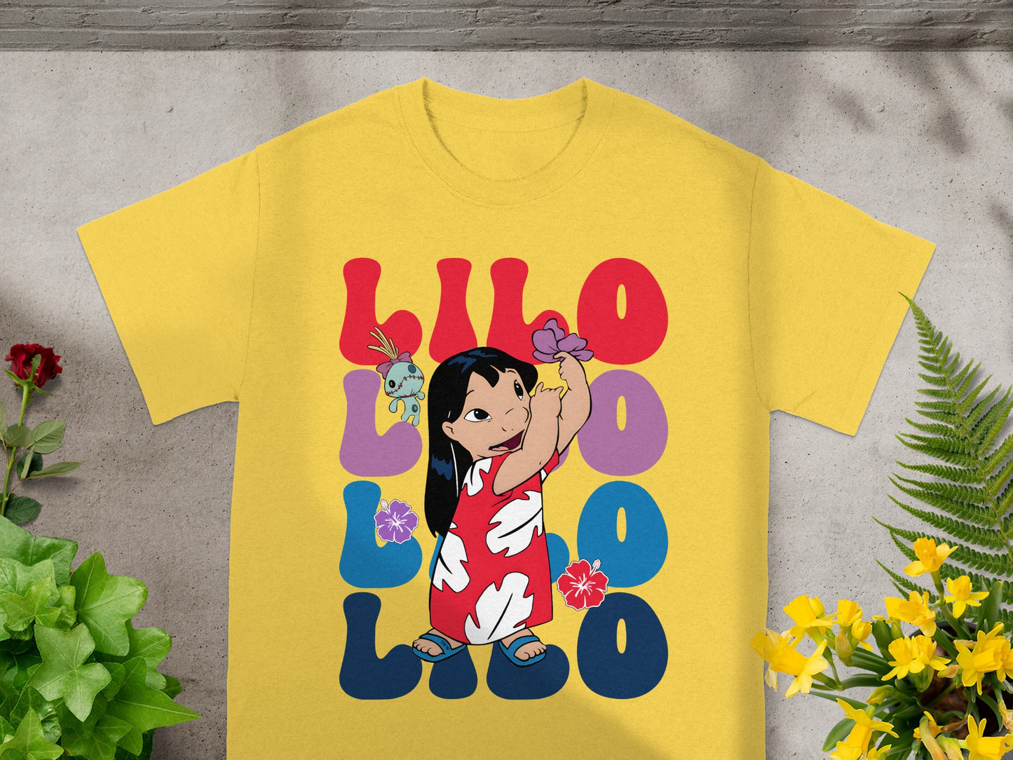 Yellow t-shirt with Lilo and Stitch graphic and text.