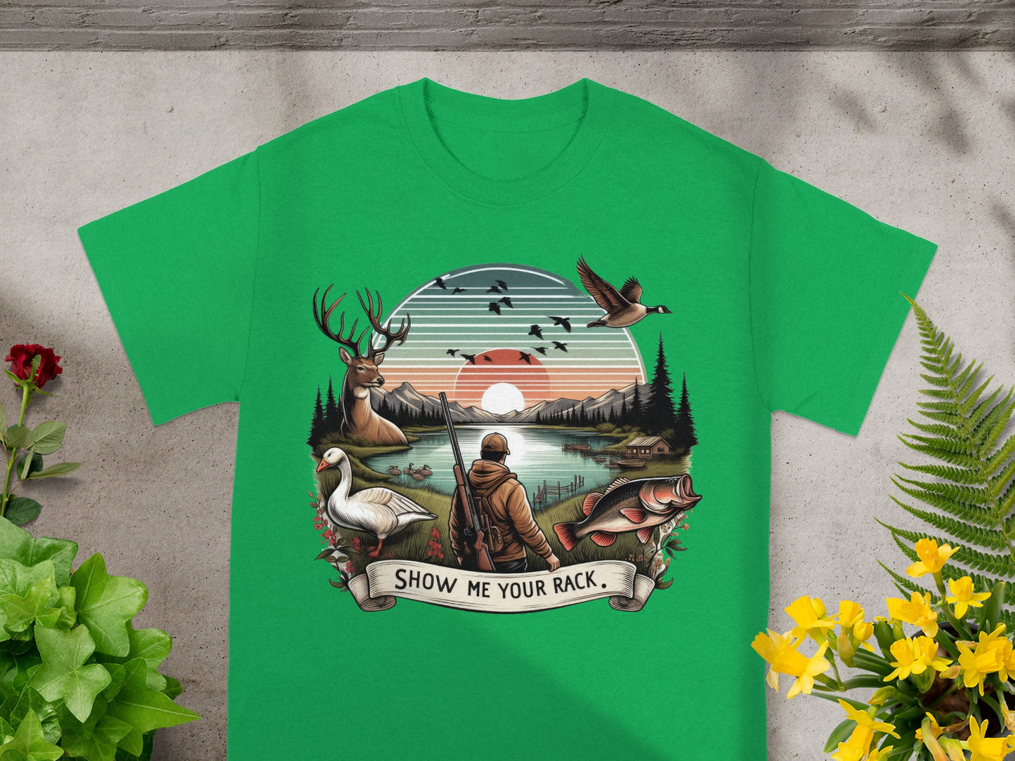Green t-shirt with a hunting and fishing graphic featuring a deer, duck, fish, and hunter.
