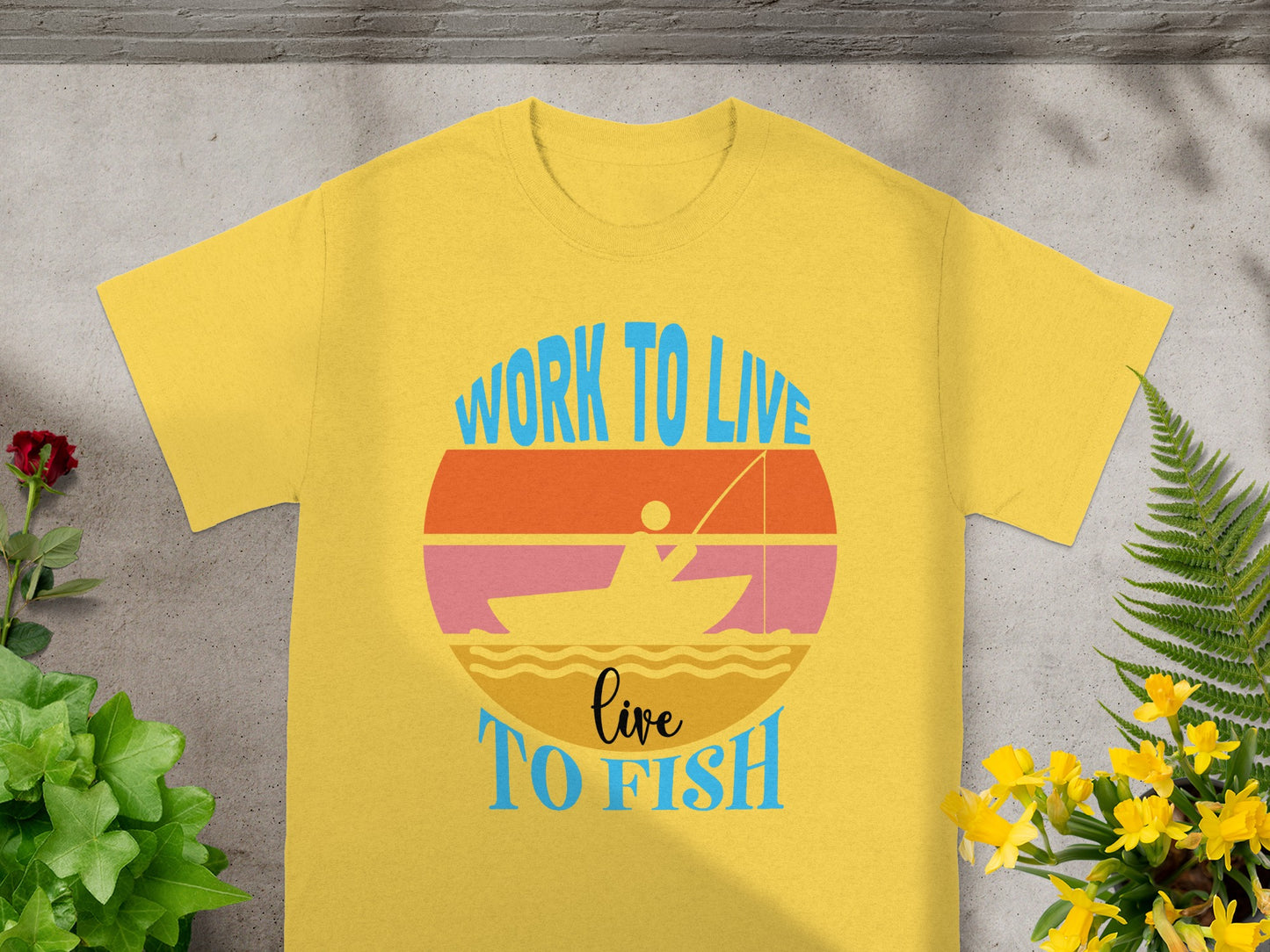 Yellow t-shirt featuring a graphic with text "WORK TO LIVE live TO FISH".