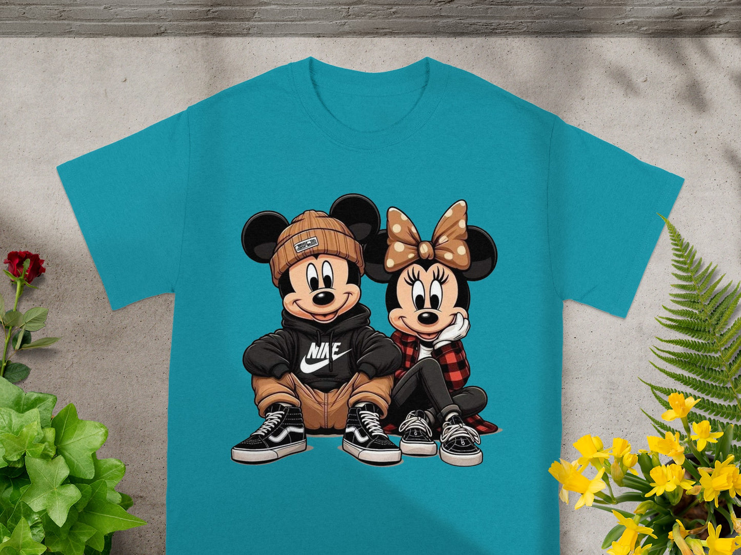Mickey and Minnie Mouse wear modern streetwear on a teal t-shirt.