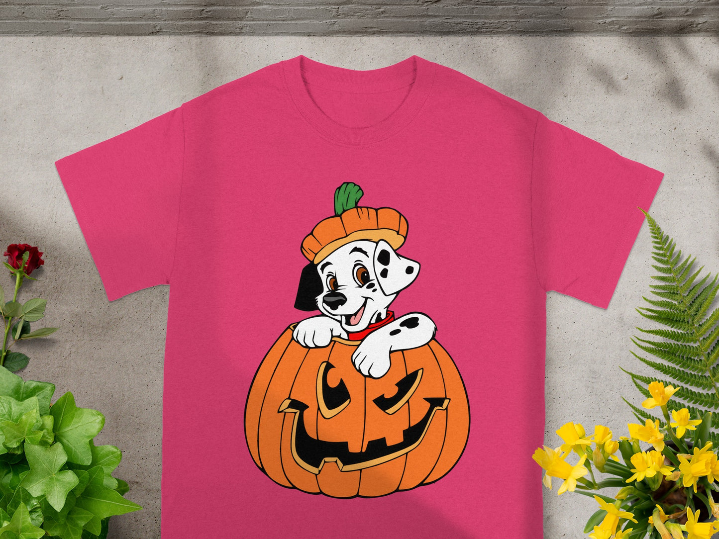 Dalmatian puppy in a pumpkin costume on a pink t-shirt.