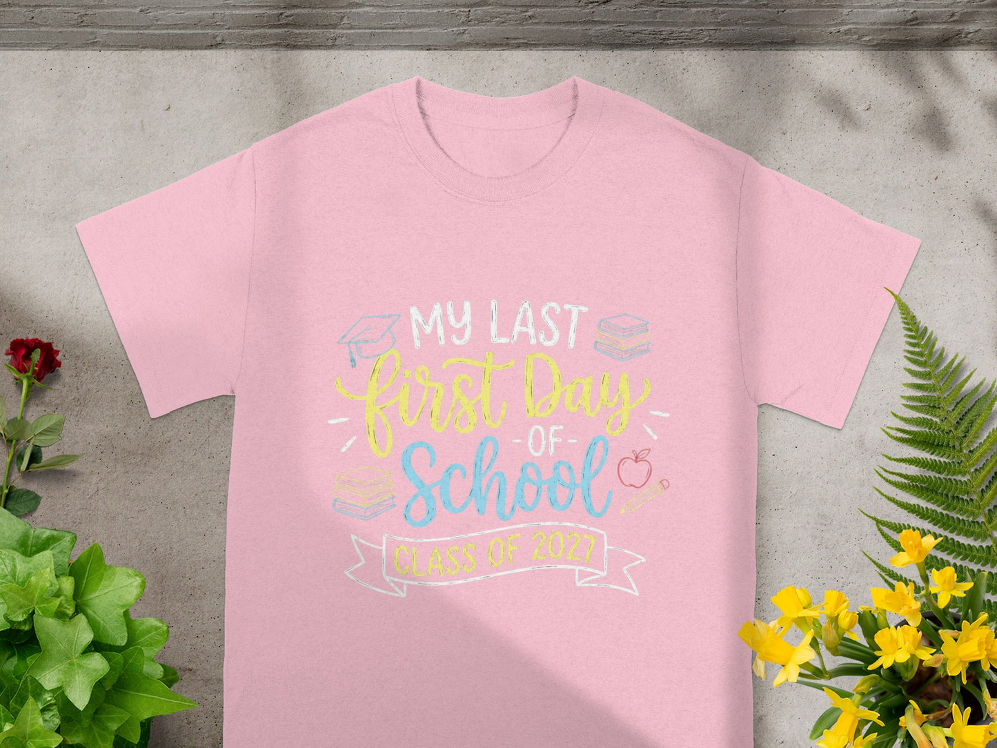 Pink t-shirt with "my last first day of school class of 2027" graphic.