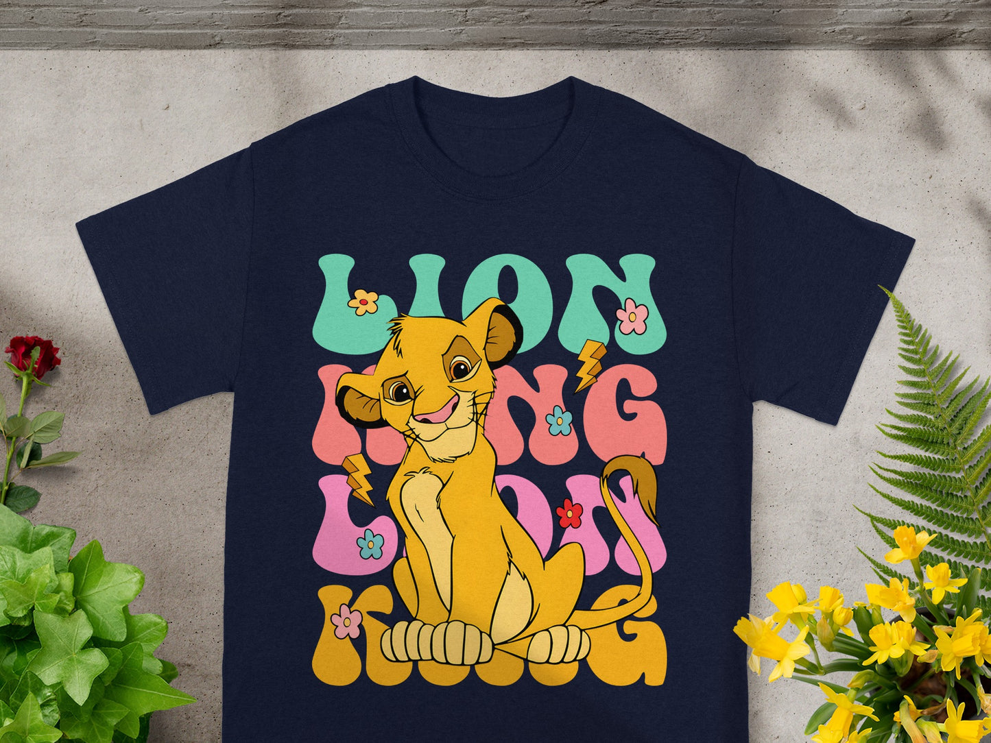 Navy t-shirt with Simba and colorful "LION KING" text.