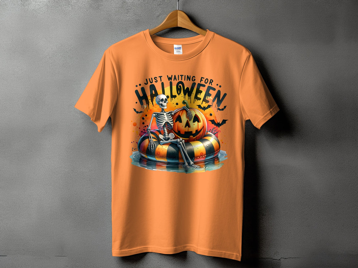 Orange t-shirt with skeleton, pumpkin, and bats graphic that says "Just Waiting For Halloween."