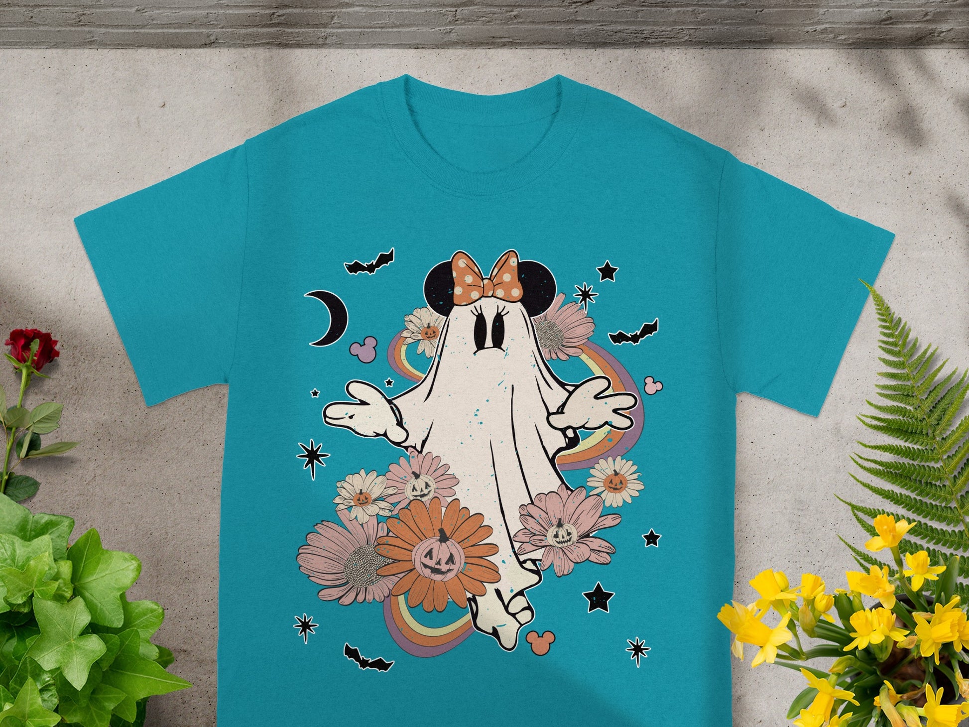 Teal t-shirt with Minnie Mouse ghost surrounded by flowers, bats, and rainbows.