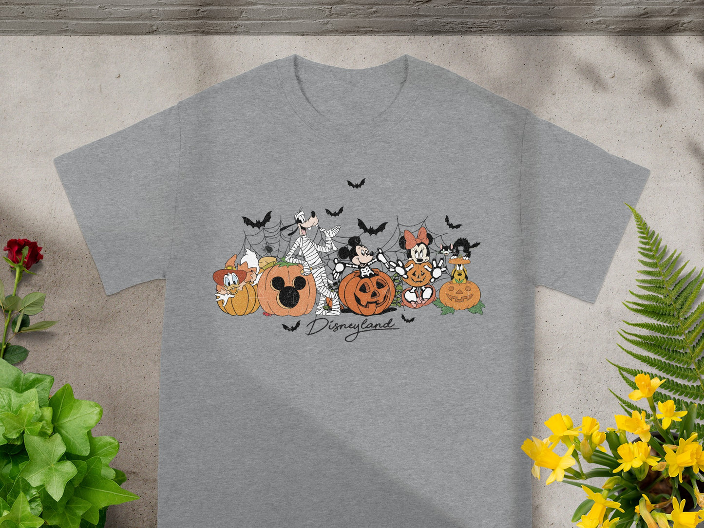 Grey t-shirt with Disney characters and pumpkins in a Halloween theme.
