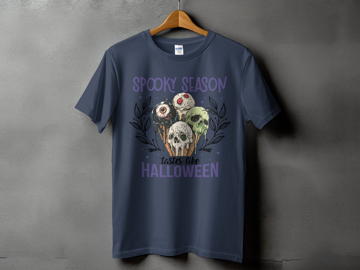 Dark blue t-shirt with "Spooky Season tastes like Halloween" and creepy ice cream cone graphic.