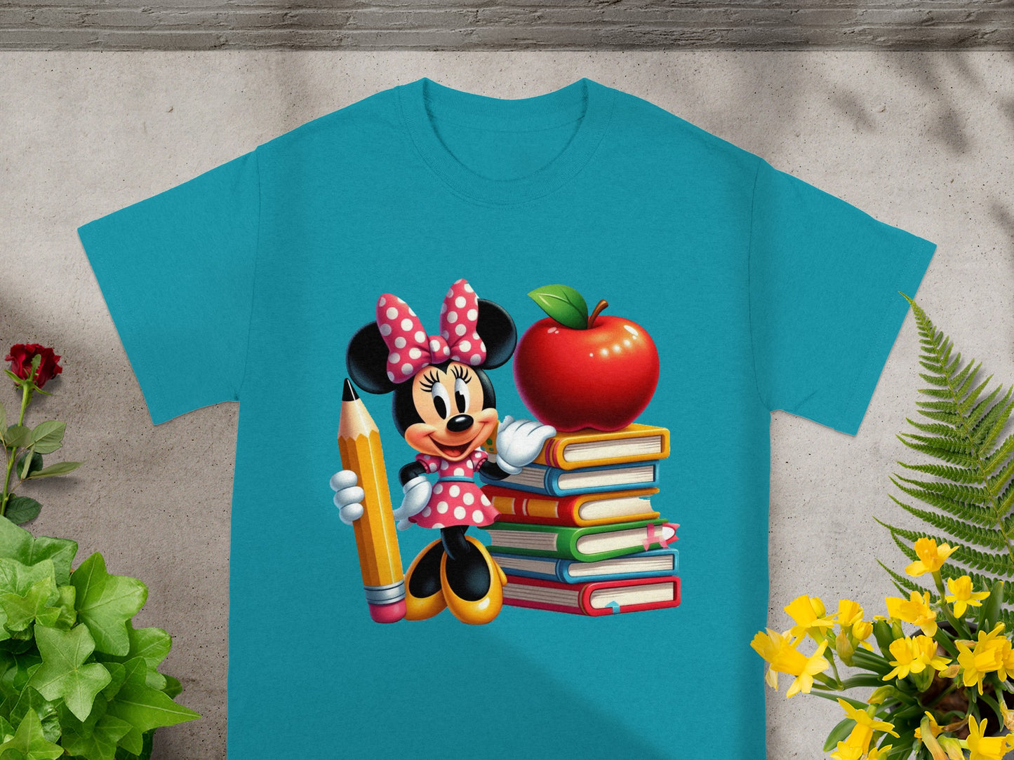 Minnie Mouse with pencil standing on stack of books next to apple.