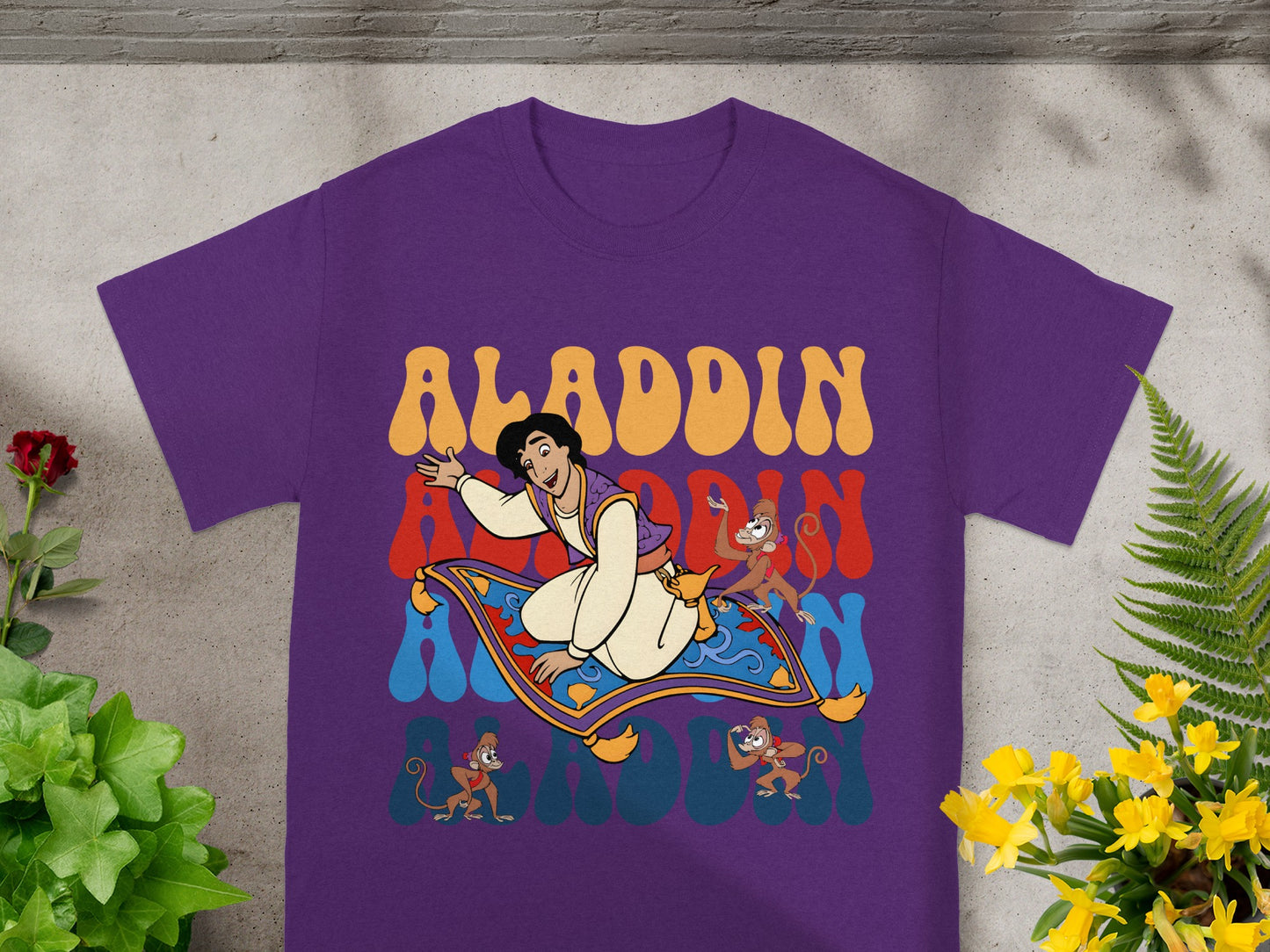 Aladdin riding a magic carpet with Abu and monkeys, "Aladdin" text.
