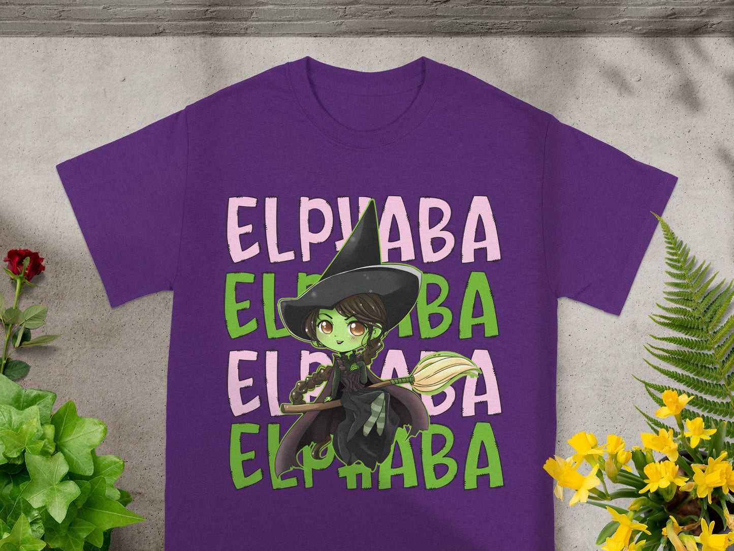 Purple t-shirt with a cartoon witch graphic and "ELPABA" text.