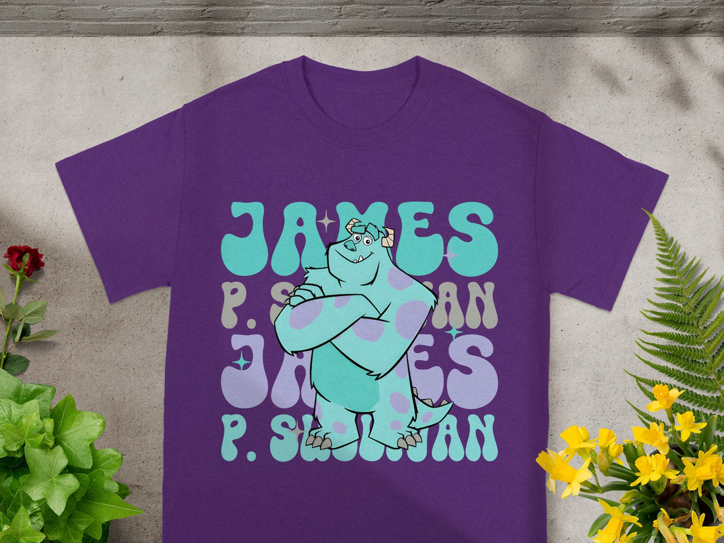 Purple t-shirt with "James P. Sullivan" printed in retro lettering.