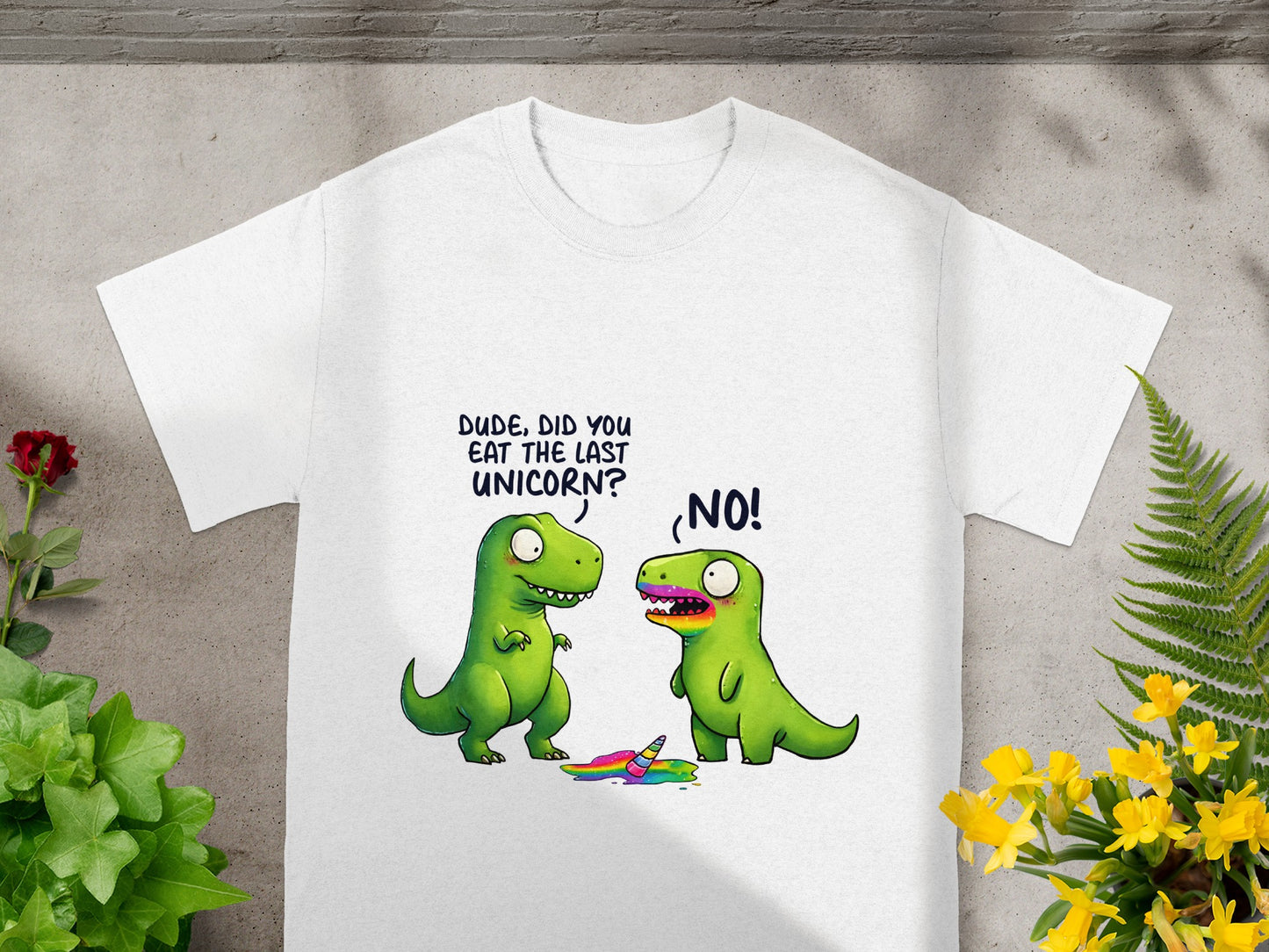 Two dinosaurs on a white t-shirt, one asks if the other ate the last unicorn.
