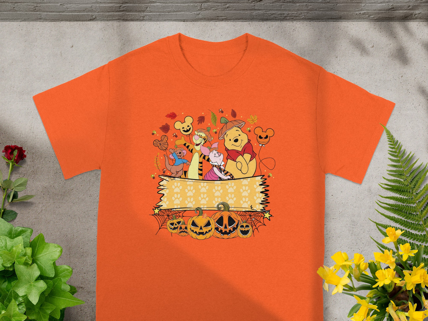 Winnie the Pooh characters and pumpkins with paw print banner Halloween graphic.