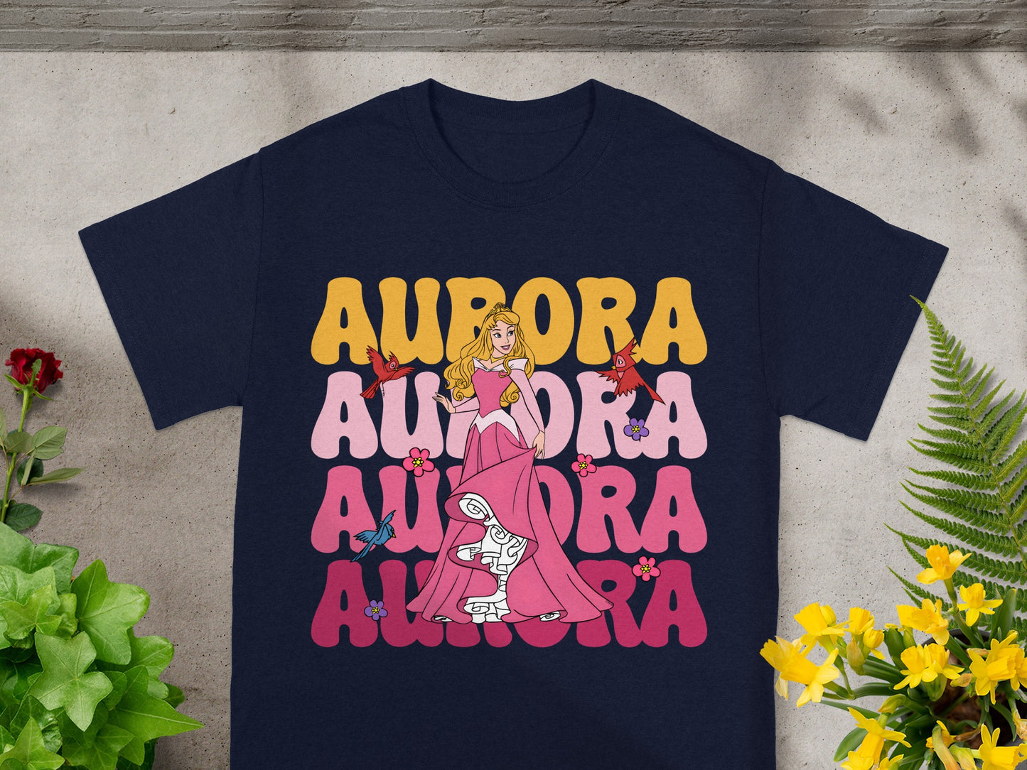 Aurora graphic on navy blue t-shirt with colorful text and Princess Aurora character.