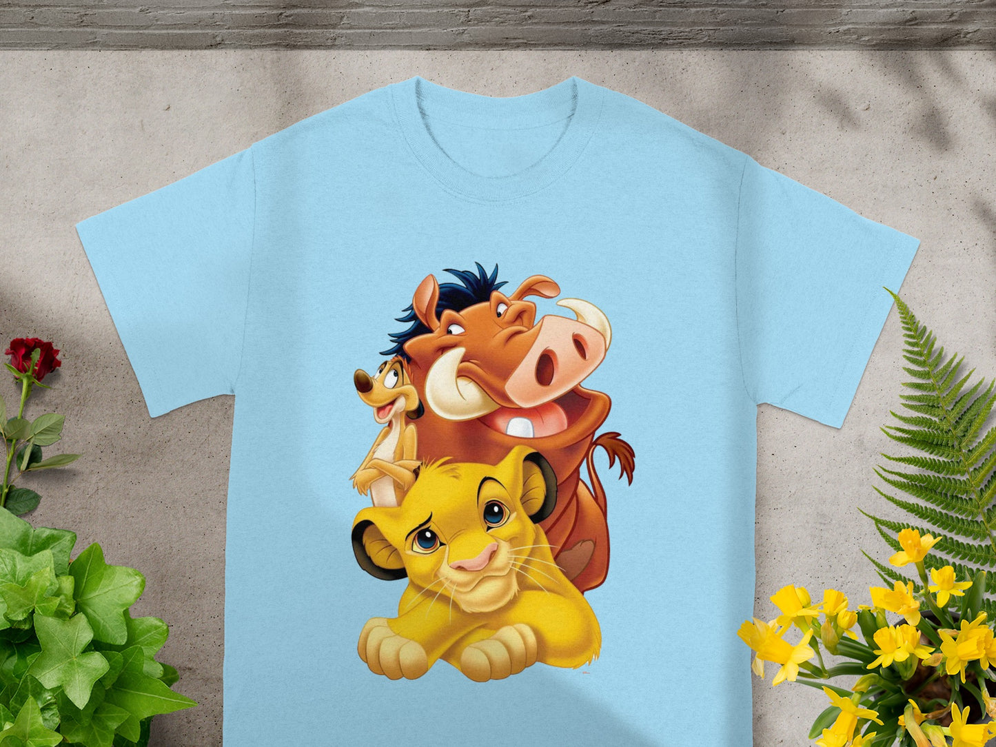 Light blue t-shirt with Simba, Pumbaa, and Timon from The Lion King cartoon.