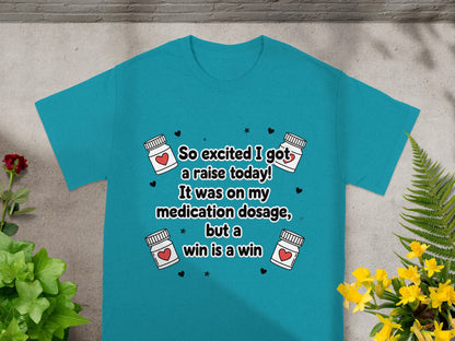 Teal t-shirt with text about medication dosage and a raise.