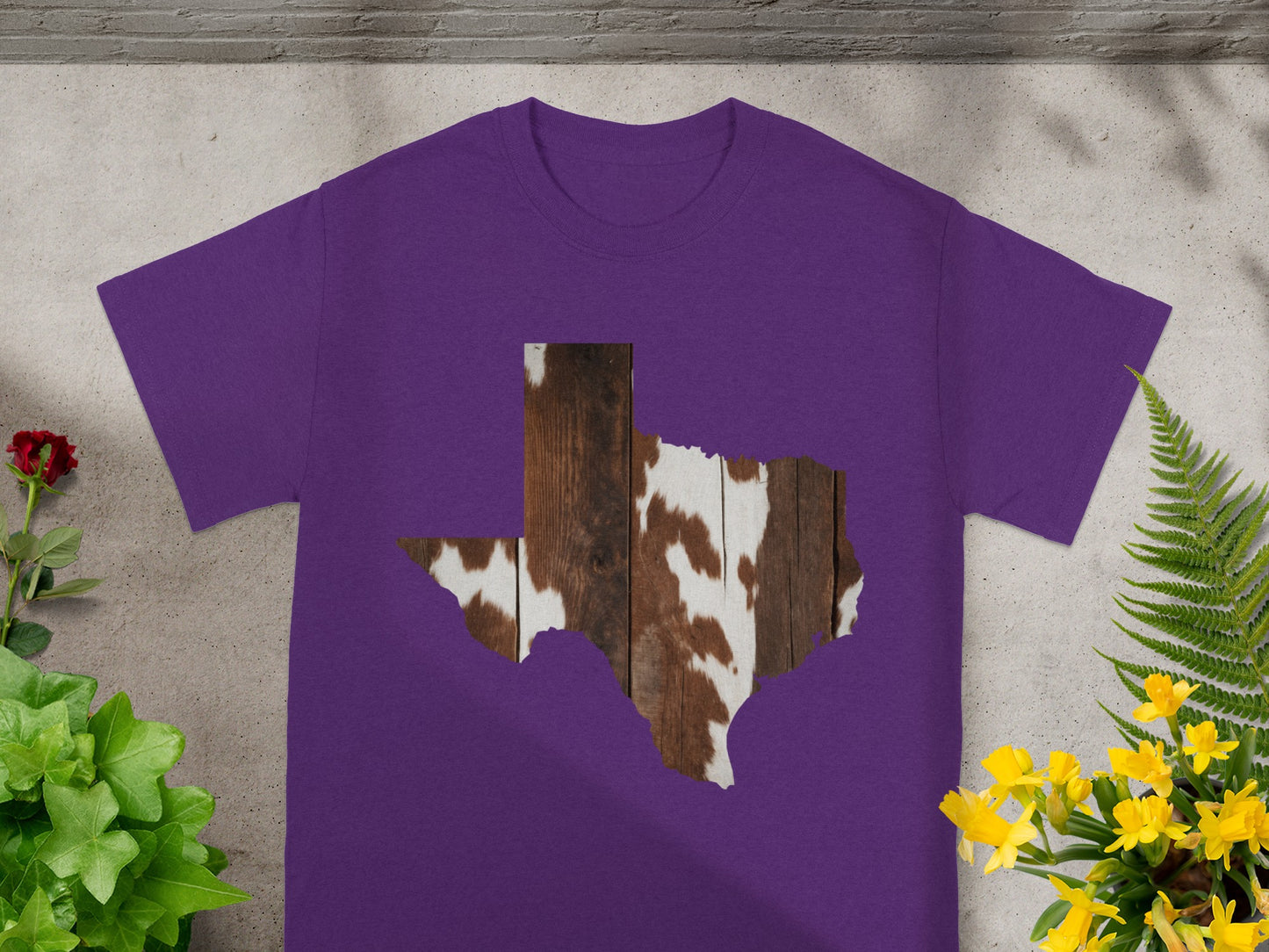 Purple t-shirt with Texas shape featuring wood and cowhide pattern.