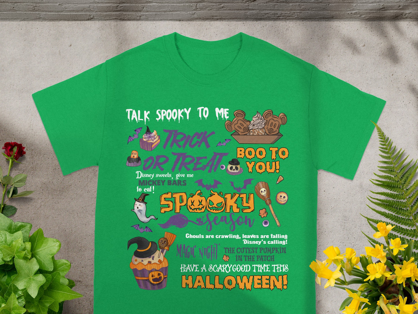 Green t-shirt with Halloween and Disney-themed graphics and text.