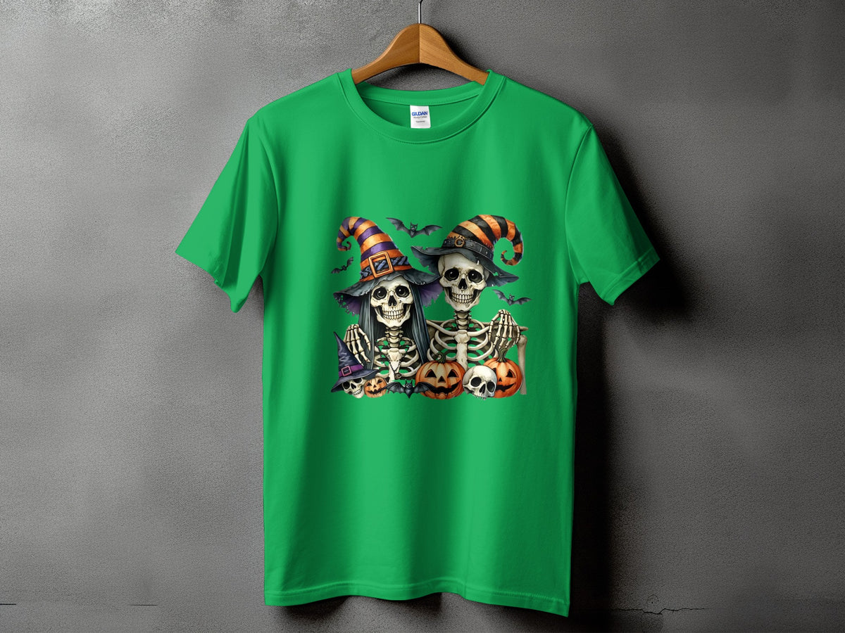 Green t-shirt with two skeletons in witch hats and pumpkins, bats and skulls.