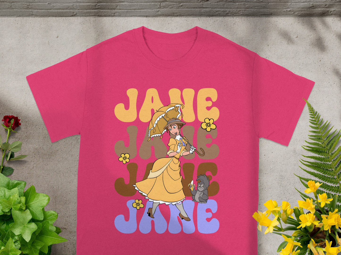 Pink t-shirt with "JANE" text and cartoon of a woman with an umbrella.