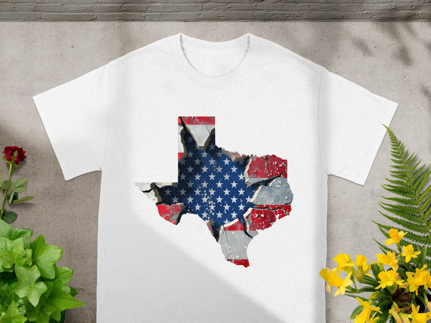 White t-shirt with cracked Texas shape overlaid with American flag design.