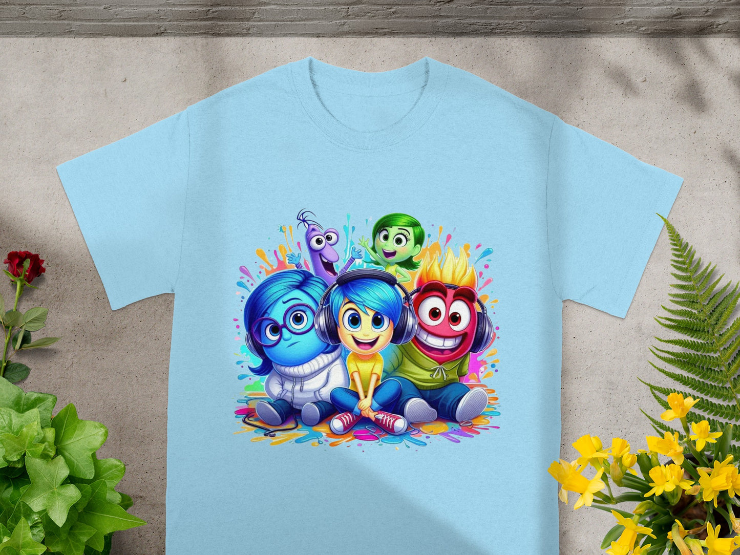 Inside Out characters Joy, Sadness, Fear, Anger, and Disgust smiling on a light blue t-shirt.