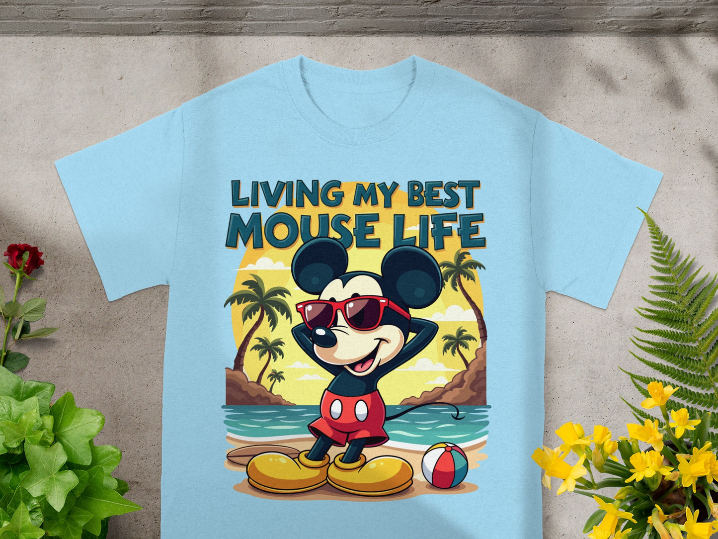 Light blue t-shirt with Mickey Mouse on a beach and text "LIVING MY BEST MOUSE LIFE".