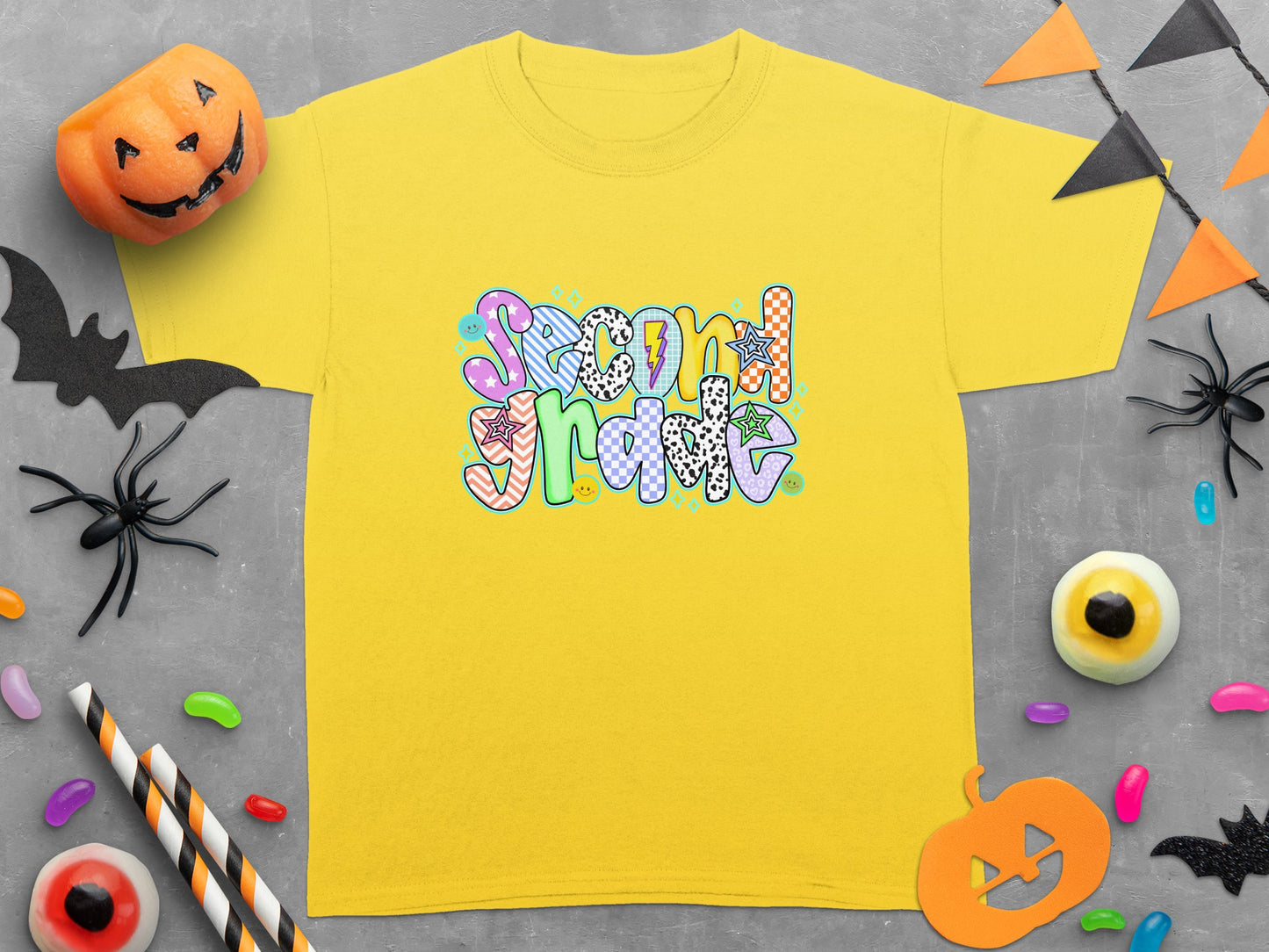 Yellow t-shirt with "Second Grade" text in colorful, patterned letters.
