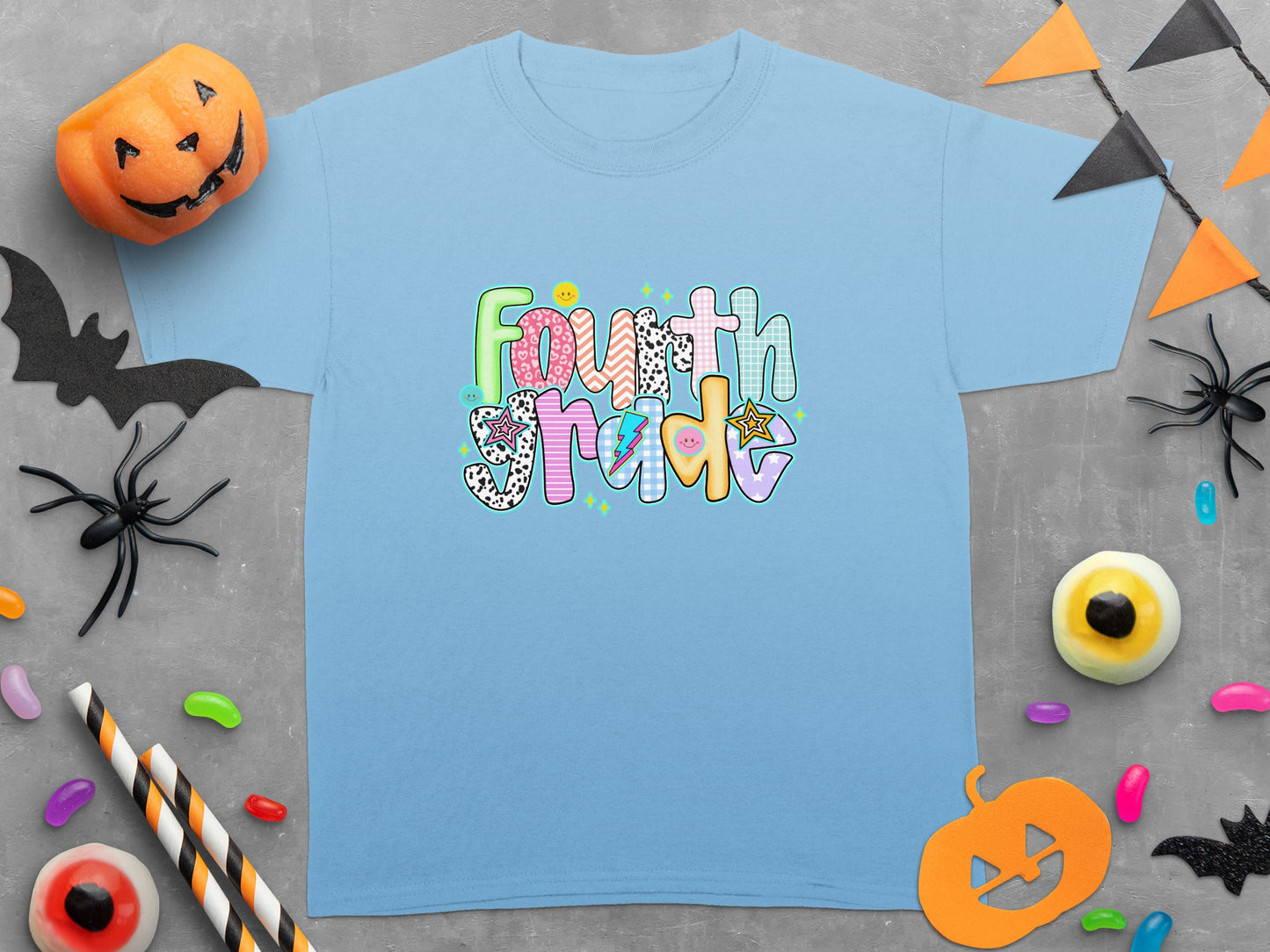 Light blue t-shirt with colorful "Fourth Grade" text and Halloween decorations.