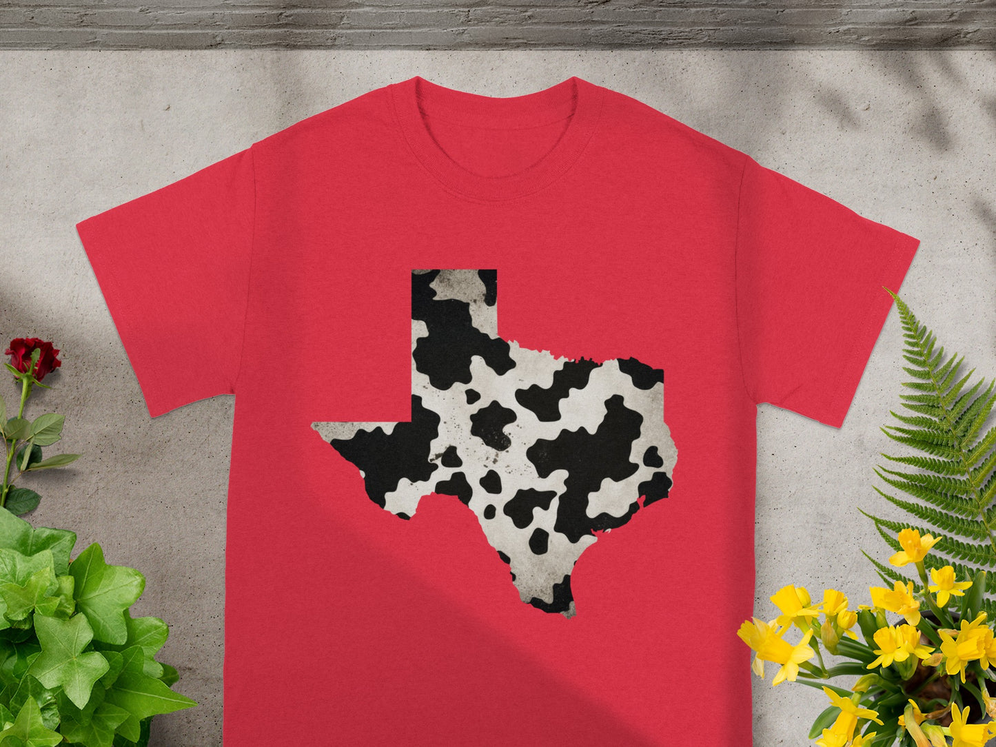 Red t-shirt with Texas map outline in cow print pattern.