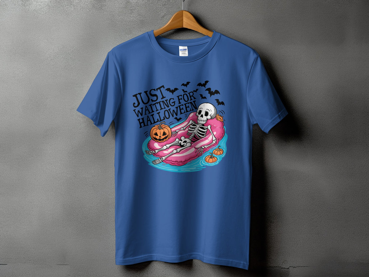 Blue t-shirt with skeleton on pink float, text "Just Waiting For Halloween," pumpkins, bats.
